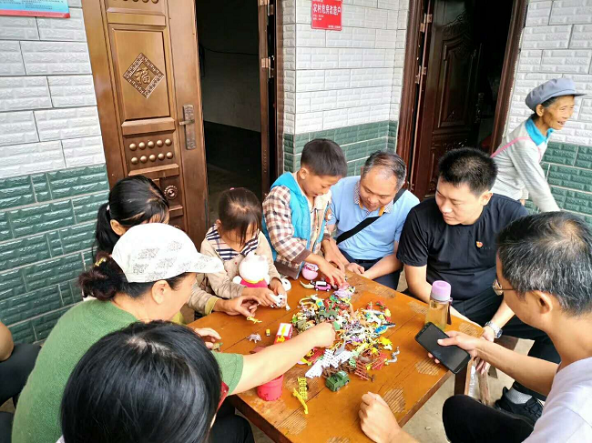 攀枝花市农工党员们陪熊才林的孩子们做沙盘游戏.png